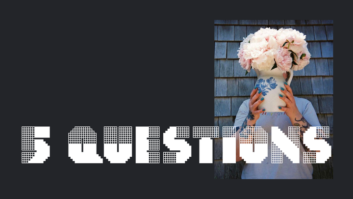 "5 Questions" in a fun white font on a black background. Off to the right side is a photo of Greta hiding behind a flower pot.